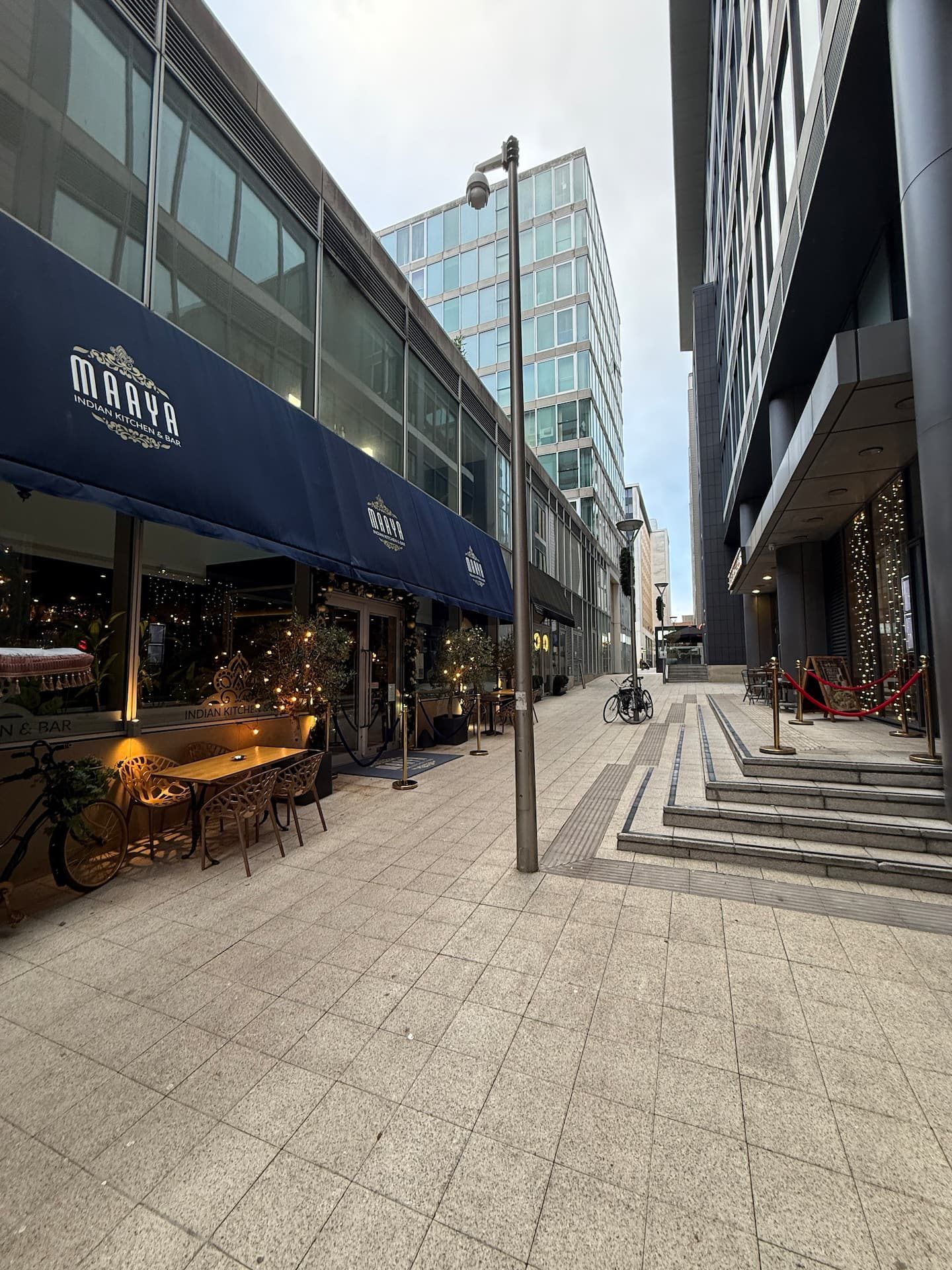 The street outside, with restaurant terraces and steps up to the square